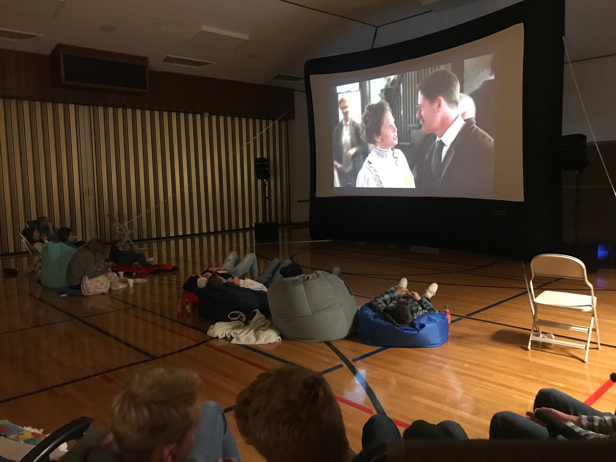 An Open Air Cinema inflatable screen set up indoors in a school gym