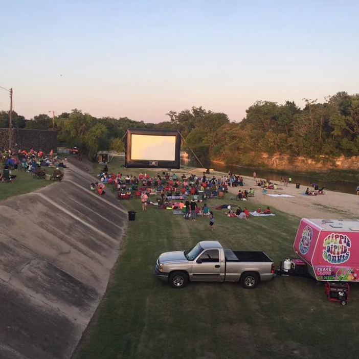 Open Air Cinema Elite 30' inflatable screen set up next to a river